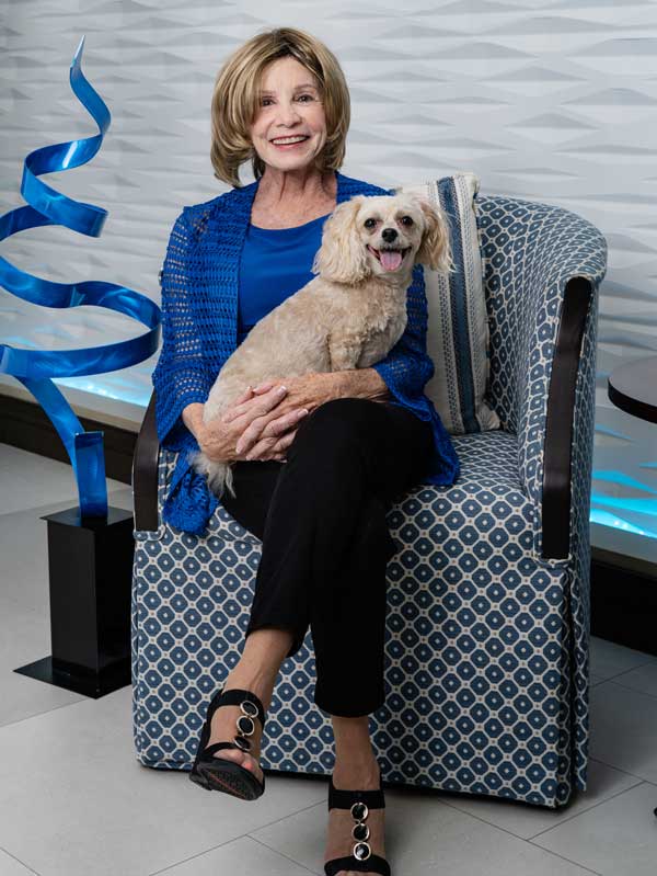 Brenda Mischka sitting with her dog